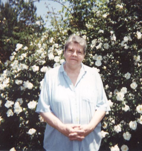 Margaret in front of a rose bush